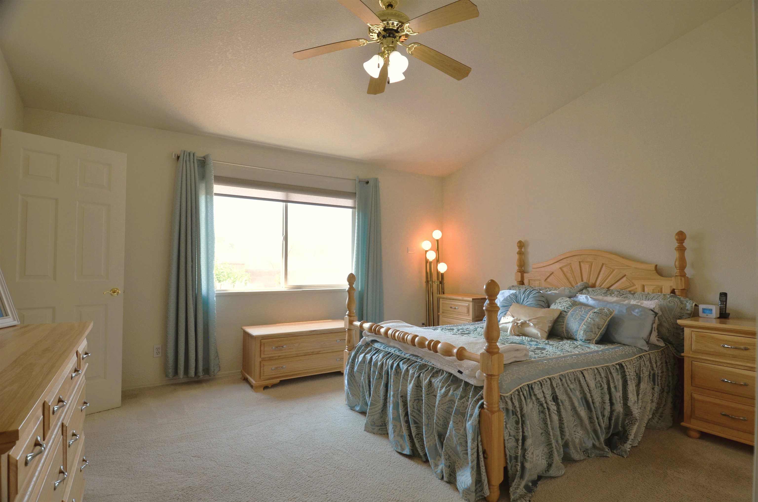 1459 Racquet Way Grand Junction, CO 81506 - Photo 29 of 42 a bedroom with a bed and a chandelier