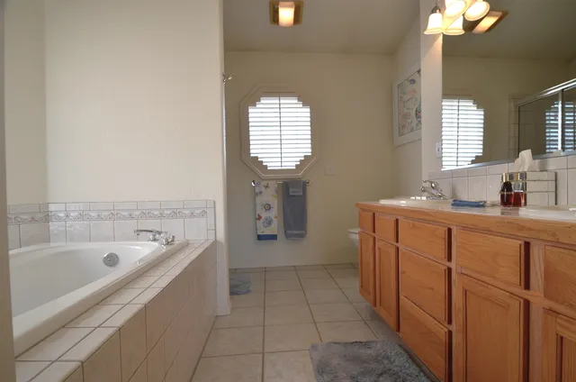 a bathroom with a bathtub sink and mirror