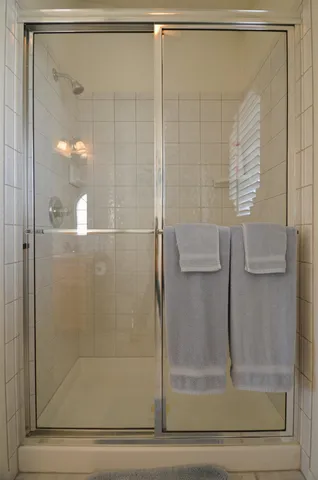 a bathroom with a glass shower door