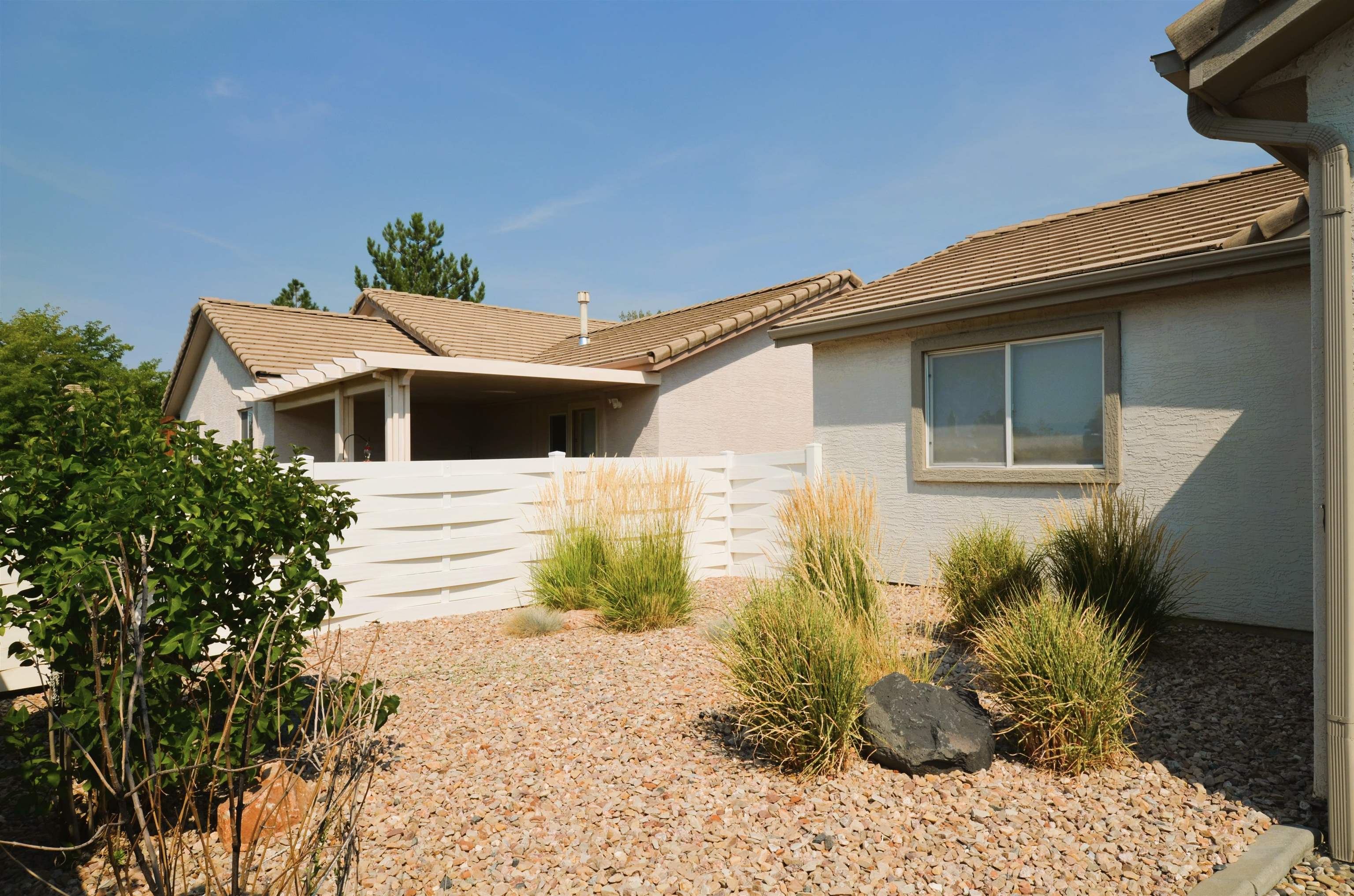 1459 Racquet Way Grand Junction, CO 81506 - Photo 8 of 42 a front view of a house with a yard
