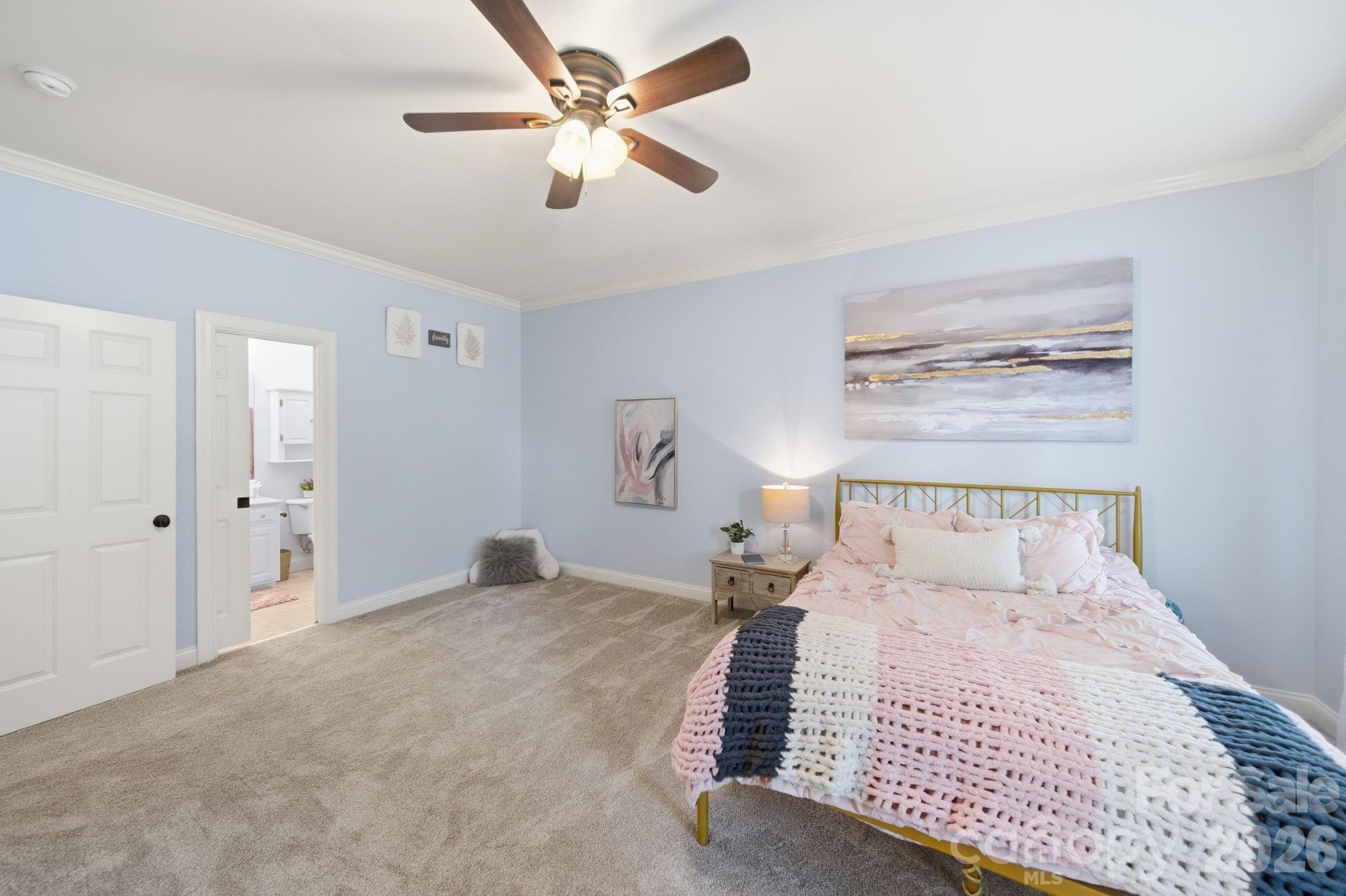 1802 Summit View Place Waxhaw, NC 28173 - Photo 32 of 47 a bedroom with a large bed and a chandelier