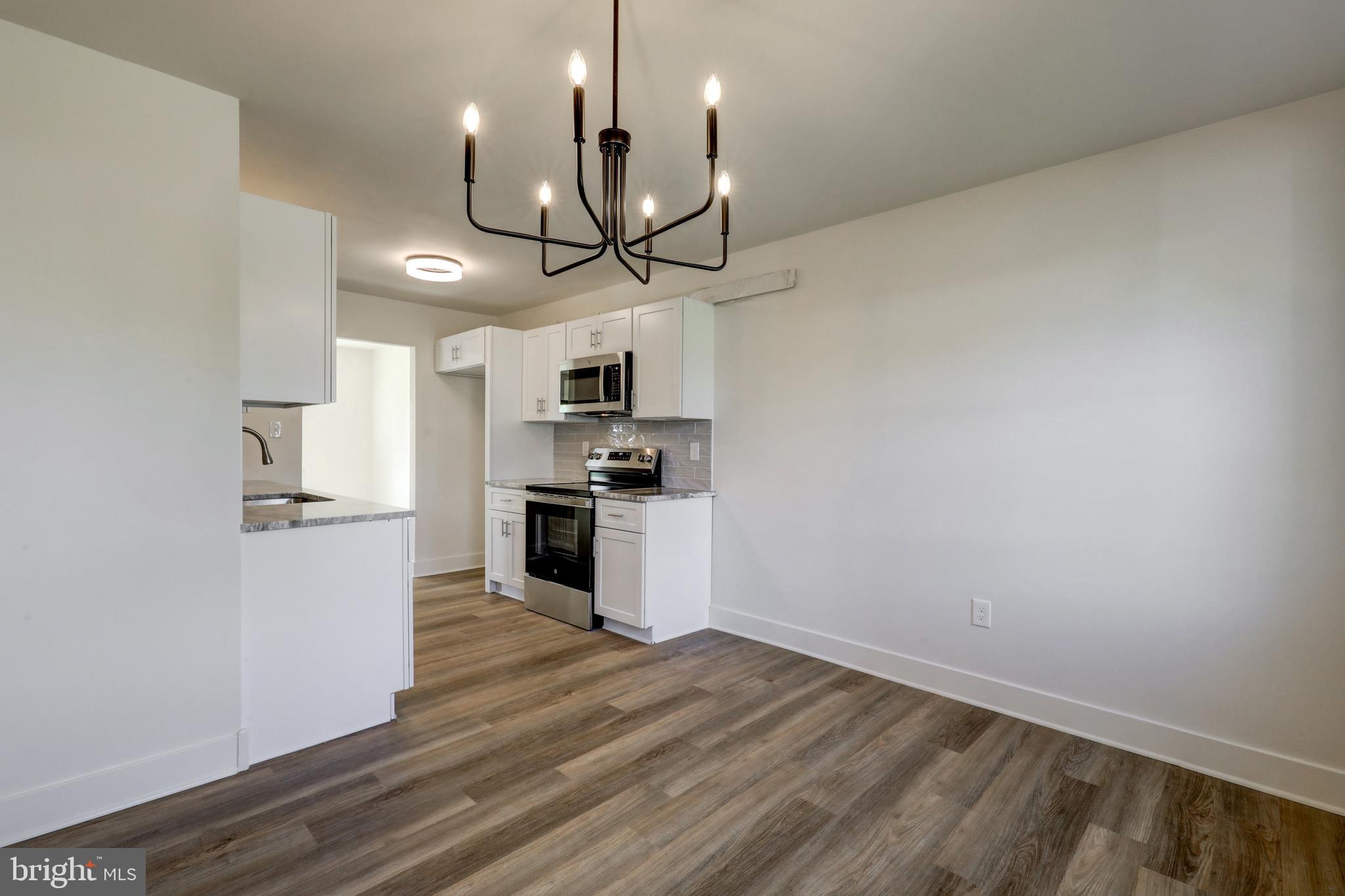 482 Crosswinds Drive Lititz, PA 17543 - Photo 6 of 36 a kitchen with stainless steel appliances a refrigerator and a wooden floor