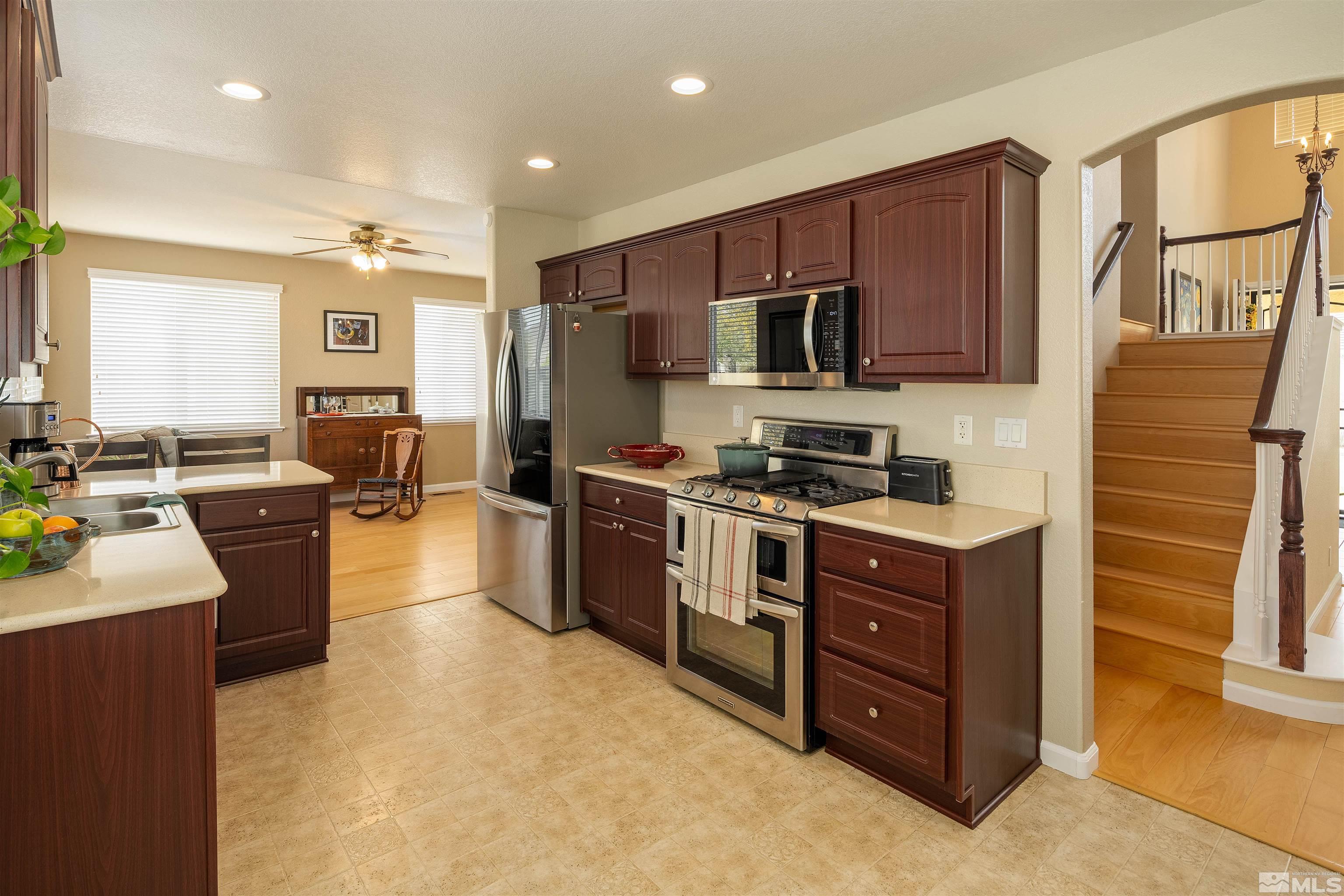 2325 Lincoln Meadows Drive Reno, NV 89521 - Photo 13 of 33 a kitchen with stainless steel appliances kitchen island granite countertop a refrigerator stove and sink