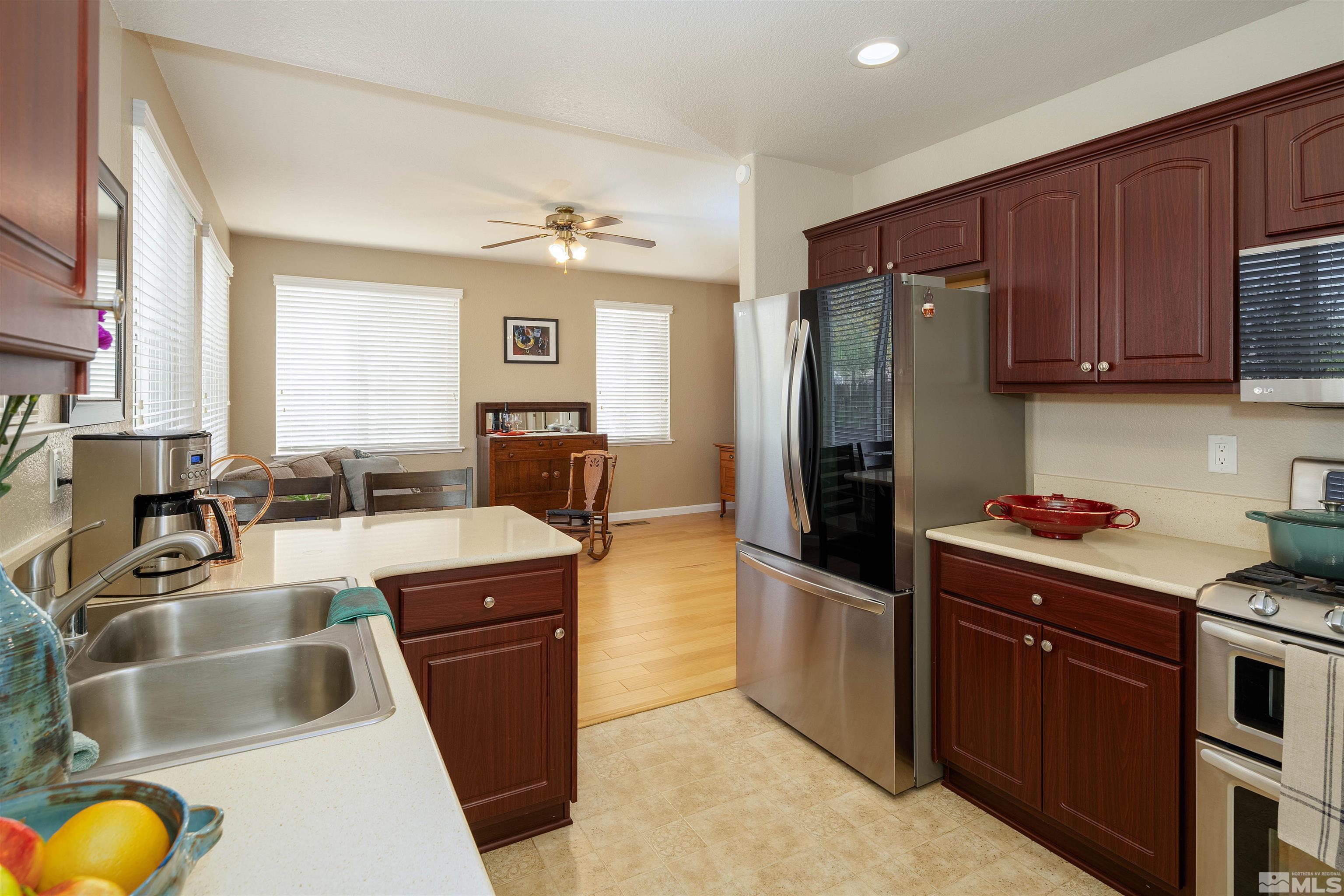 2325 Lincoln Meadows Drive Reno, NV 89521 - Photo 15 of 33 a kitchen with a refrigerator sink and wooden cabinets