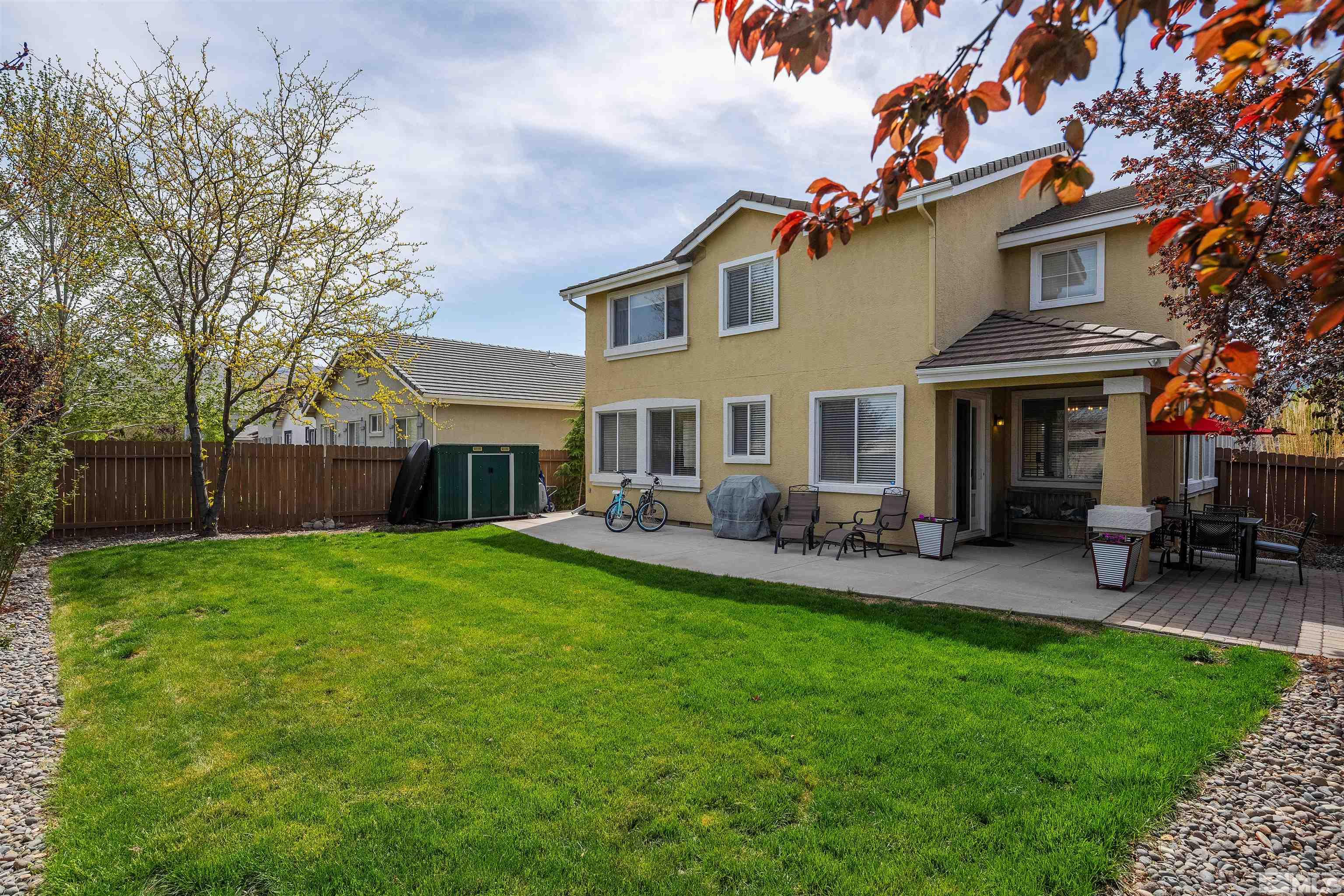 2325 Lincoln Meadows Drive Reno, NV 89521 - Photo 22 of 33 a front view of a house with a garden and patio