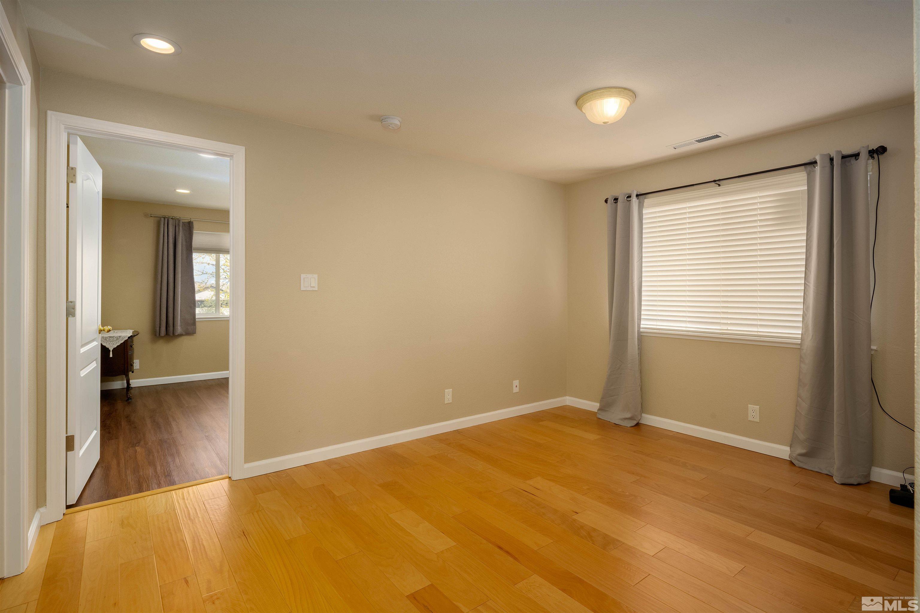 2325 Lincoln Meadows Drive Reno, NV 89521 - Photo 26 of 33 a view of an empty room with wooden floor
