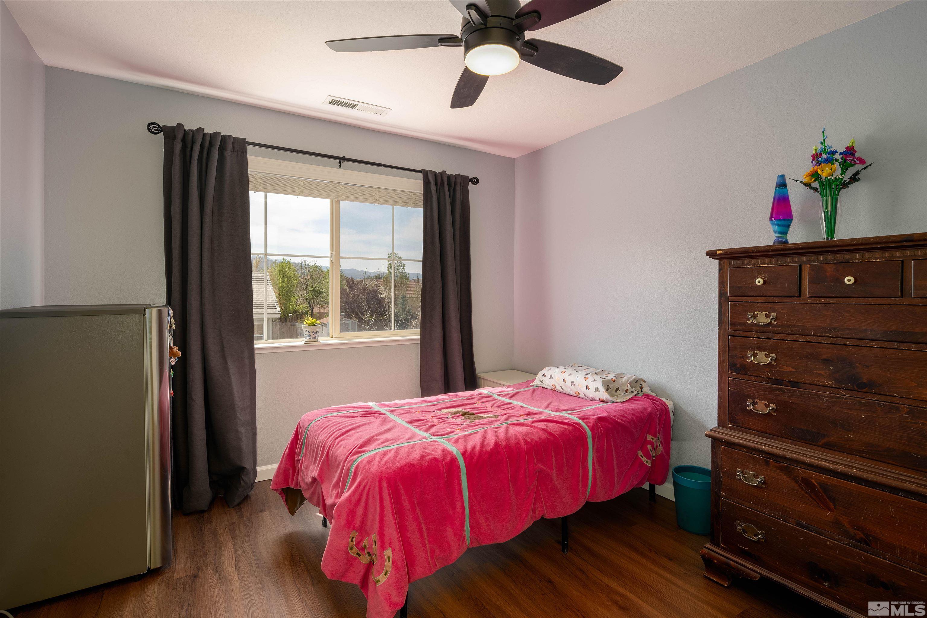 2325 Lincoln Meadows Drive Reno, NV 89521 - Photo 32 of 33 a bedroom with a bed and a window