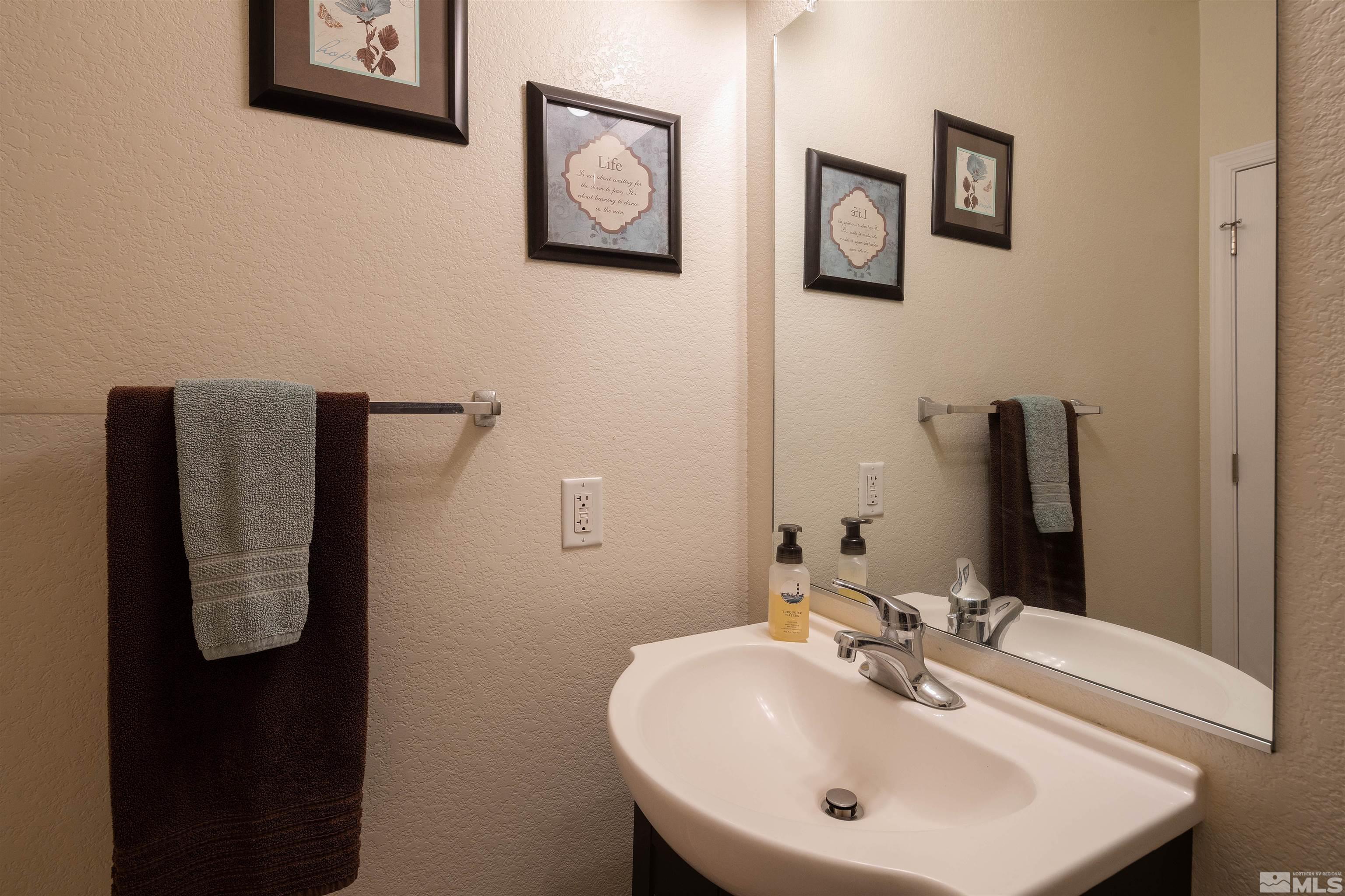 2325 Lincoln Meadows Drive Reno, NV 89521 - Photo 33 of 33 a bathroom with a sink and mirror