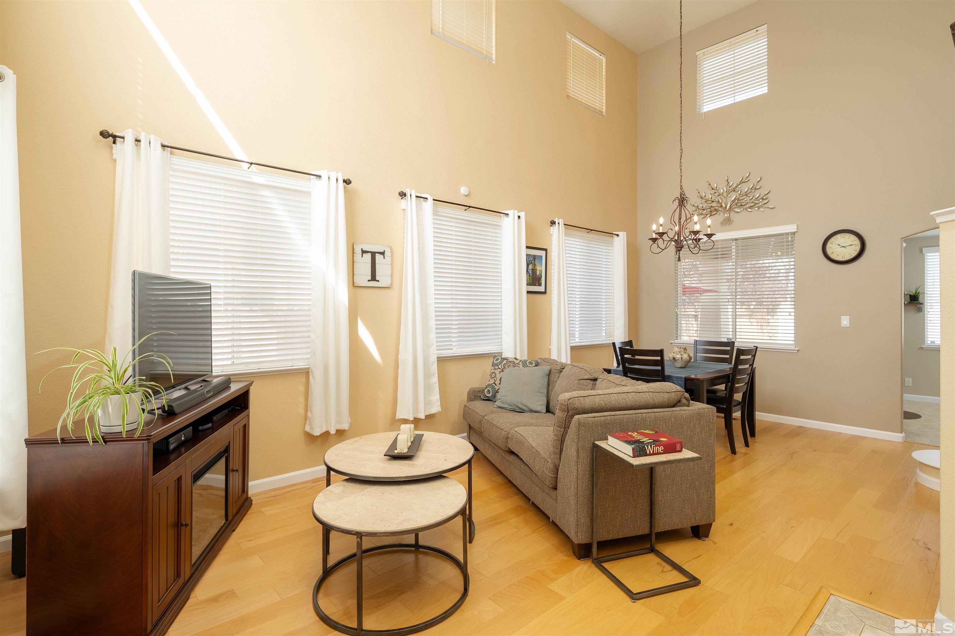 2325 Lincoln Meadows Drive Reno, NV 89521 - Photo 7 of 33 a living room with furniture and a floor to ceiling window