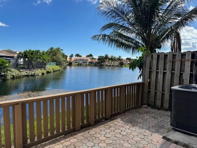 a balcony with wooden floor and lake view