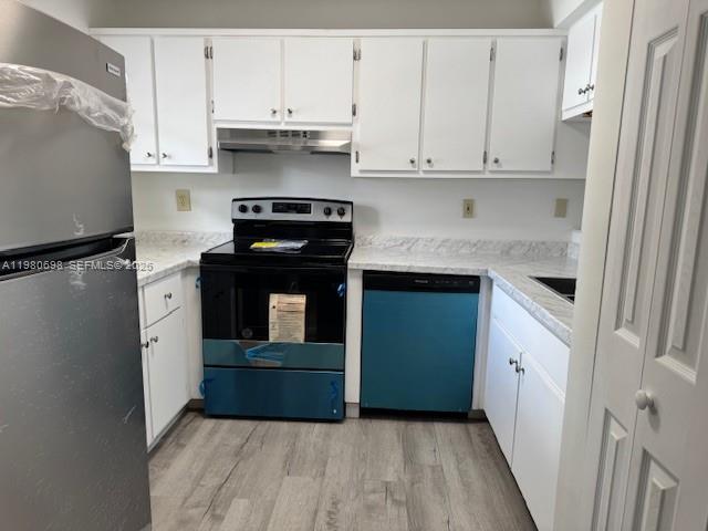 13404 Southwest 62nd Street, Unit 101L Miami, FL 33183 - Photo 14 of 46 a kitchen with a stove refrigerator and cabinets