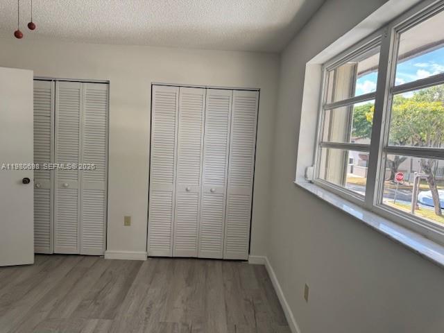 13404 Southwest 62nd Street, Unit 101L Miami, FL 33183 - Photo 20 of 46 wooden floor in an empty room with a window
