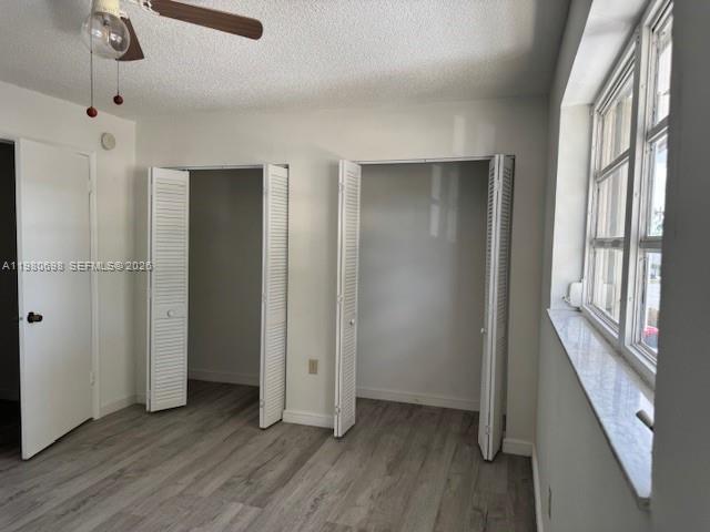 13404 Southwest 62nd Street, Unit 101L Miami, FL 33183 - Photo 23 of 46 an empty room with wooden floor and windows