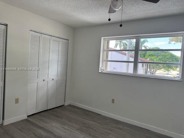 13404 Southwest 62nd Street, Unit 101L Miami, FL 33183 - Photo 25 of 46 an empty room with wooden floor and windows