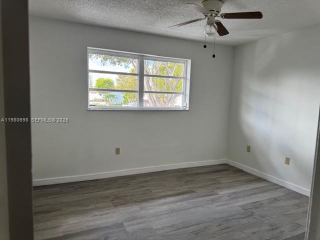 13404 Southwest 62nd Street, Unit 101L Miami, FL 33183 - Photo 26 of 46 wooden floor in an empty room with a window