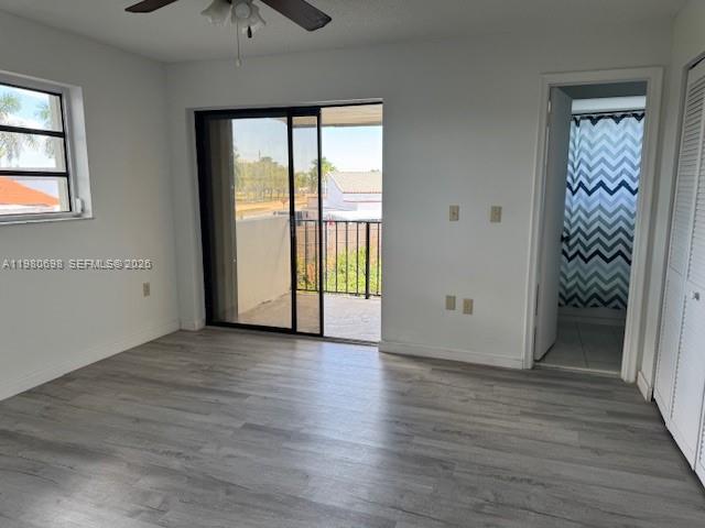 13404 Southwest 62nd Street, Unit 101L Miami, FL 33183 - Photo 31 of 46 an empty room with wooden floor cabinet and windows