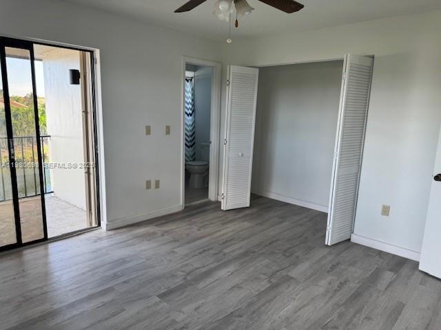 13404 Southwest 62nd Street, Unit 101L Miami, FL 33183 - Photo 32 of 46 an empty room with wooden floor cabinet and windows