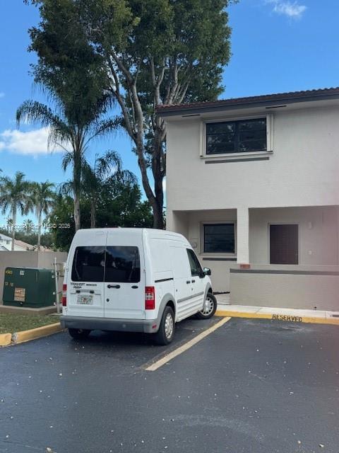 13404 Southwest 62nd Street, Unit 101L Miami, FL 33183 - Photo 42 of 46 a white car parked in front of a house