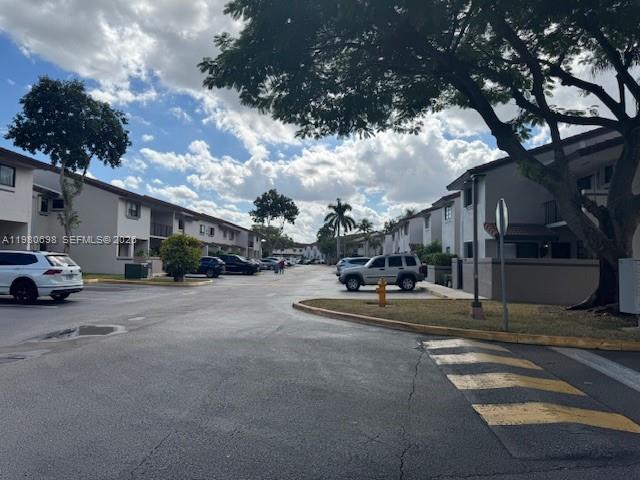 13404 Southwest 62nd Street, Unit 101L Miami, FL 33183 - Photo 45 of 46 a view of street with parked cars