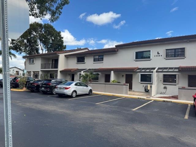 13404 Southwest 62nd Street, Unit 101L Miami, FL 33183 - Photo 46 of 46 a view of a cars parked in front of a house