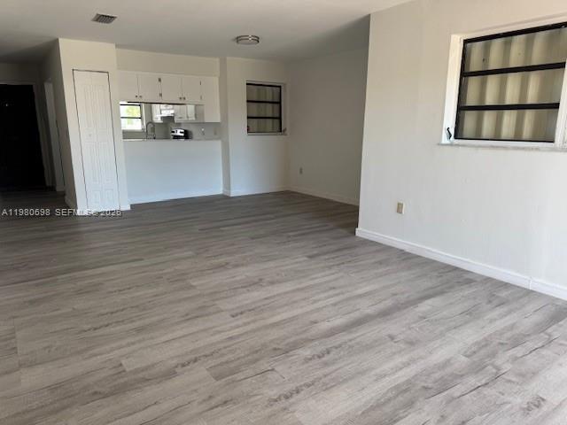13404 Southwest 62nd Street, Unit 101L Miami, FL 33183 - Photo 10 of 46 a view of a kitchen with wooden floor and a refrigerator
