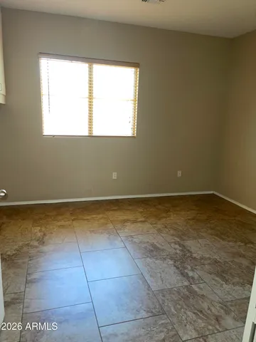 a view of a room with wooden floor and a window