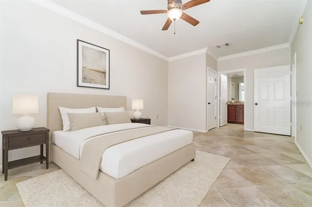 a spacious bedroom with a bed and a chandelier