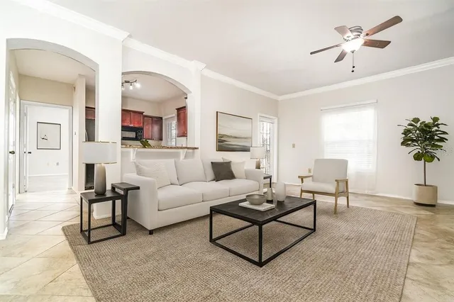 a living room with furniture and a potted plant