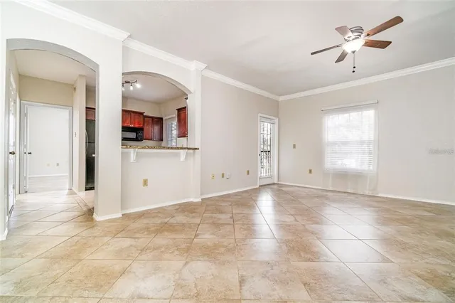 a view of a kitchen with wooden cabinet and a ceiling fan
