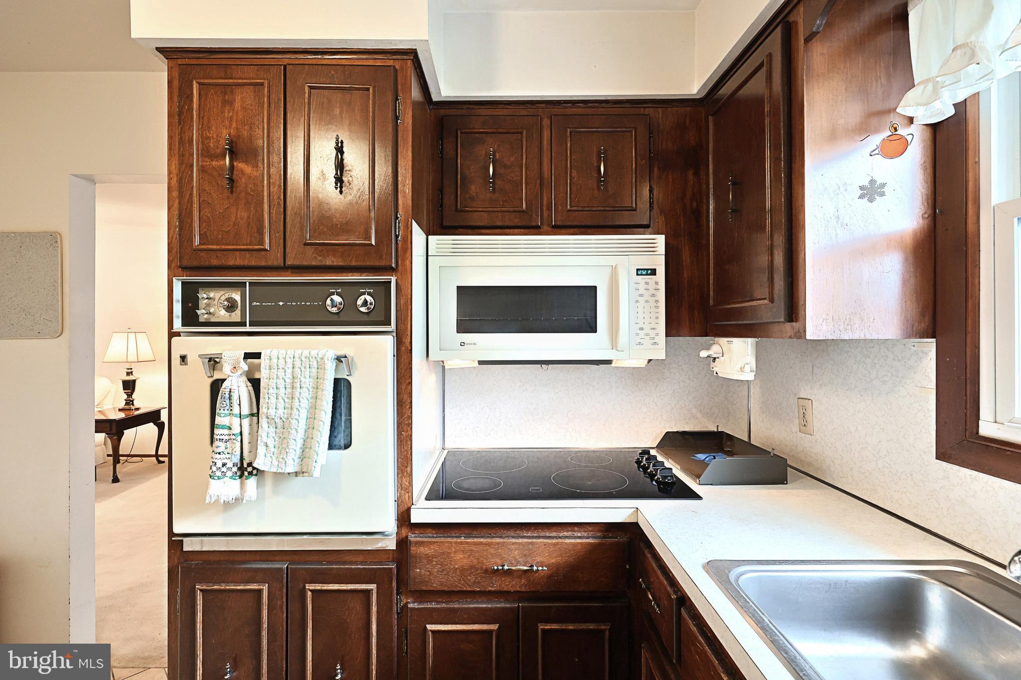 406 Spring Forge Drive Spring Grove, PA 17362 - Photo 22 of 53 a kitchen with stainless steel appliances granite countertop a stove a sink and a microwave