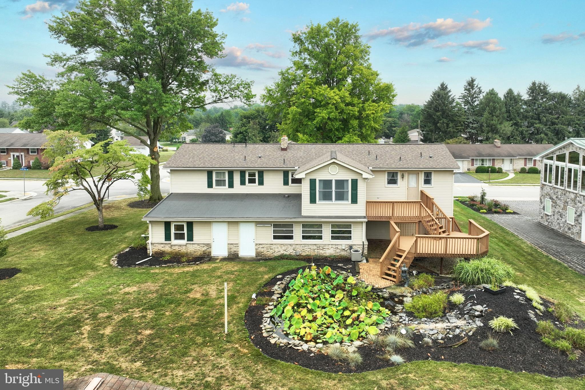 406 Spring Forge Drive Spring Grove, PA 17362 - Photo 6 of 53 a view of a white house with a yard table and chairs