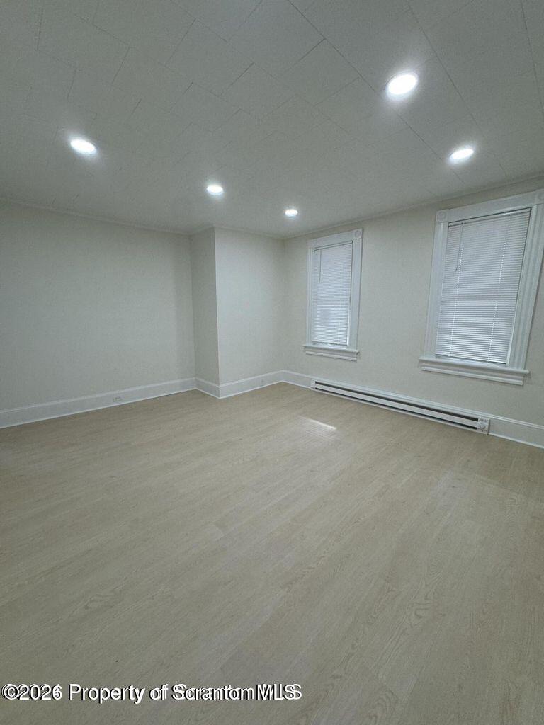 538 North Sumner Avenue, Unit 1 Scranton, PA 18504 - Photo 2 of 11 an empty room with wooden floor and windows