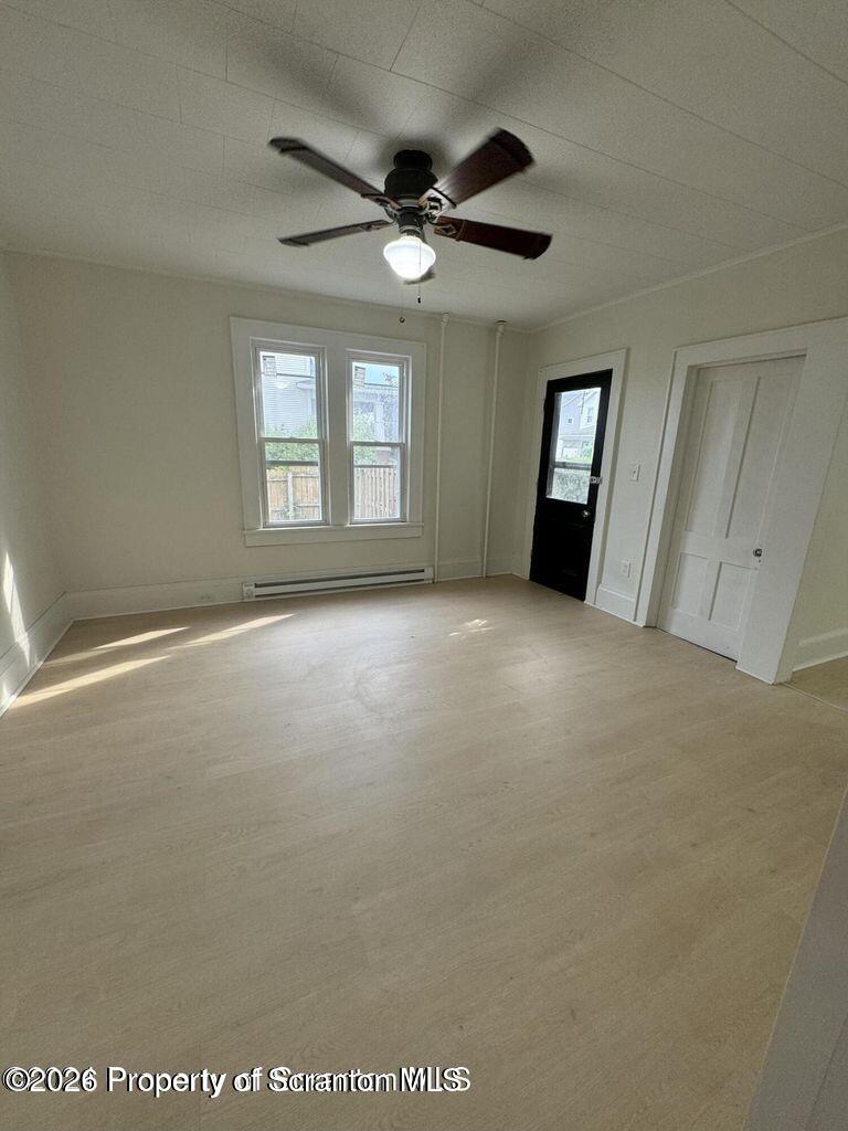 538 North Sumner Avenue, Unit 1 Scranton, PA 18504 - Photo 6 of 11 an empty room with windows and ceiling fan