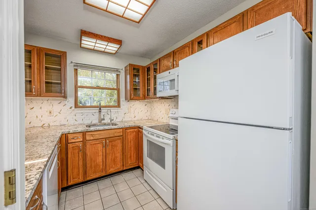 a white refrigerator freezer sitting inside of a kitchen