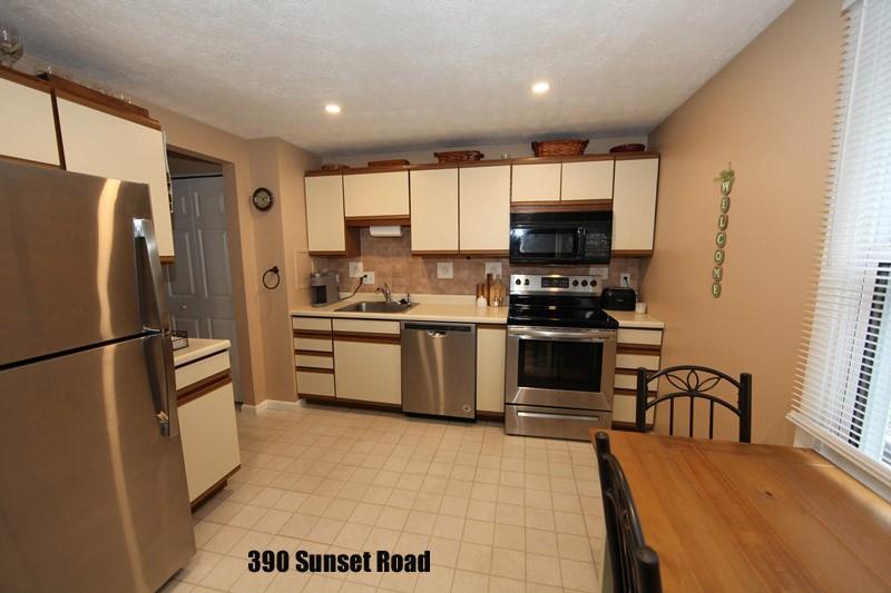 390-392 Sunset Road Pittsburgh, PA 15237 - Photo 19 of 25 a kitchen with granite countertop a refrigerator a stove a microwave and a sink