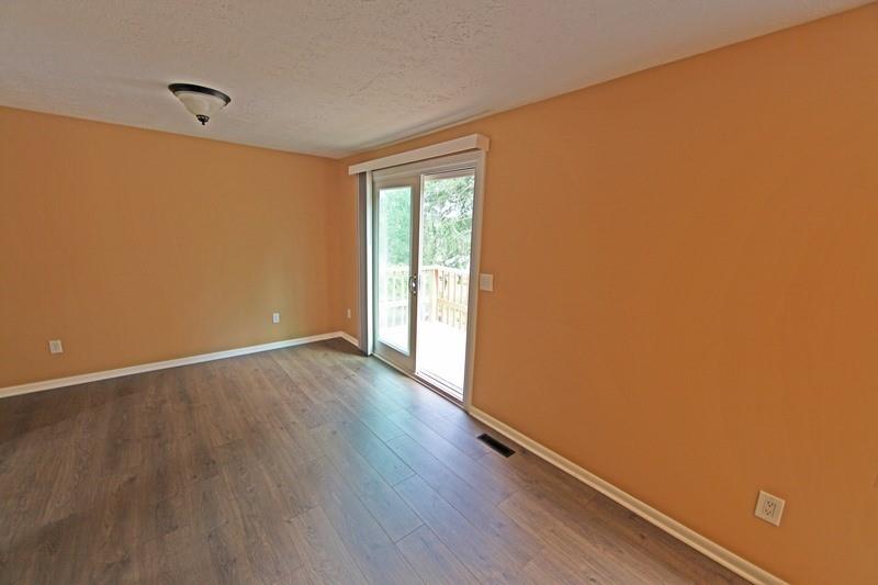 390-392 Sunset Road Pittsburgh, PA 15237 - Photo 5 of 25 a view of an empty room with wooden floor and a window