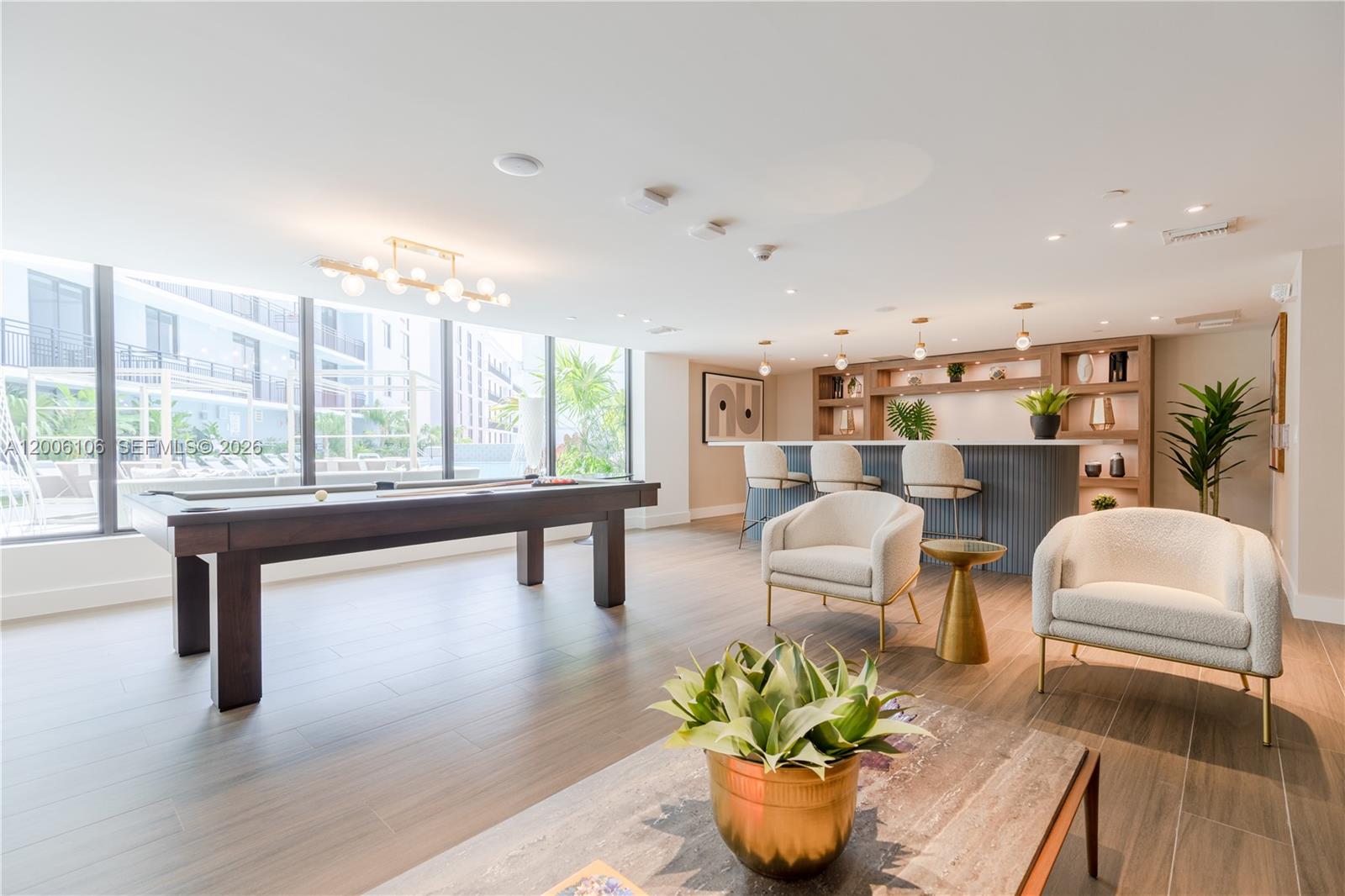 1005 Spring Garden Road, Unit 555 Miami, FL 33136 - Photo 22 of 35 a living room with kitchen island furniture and a potted plant