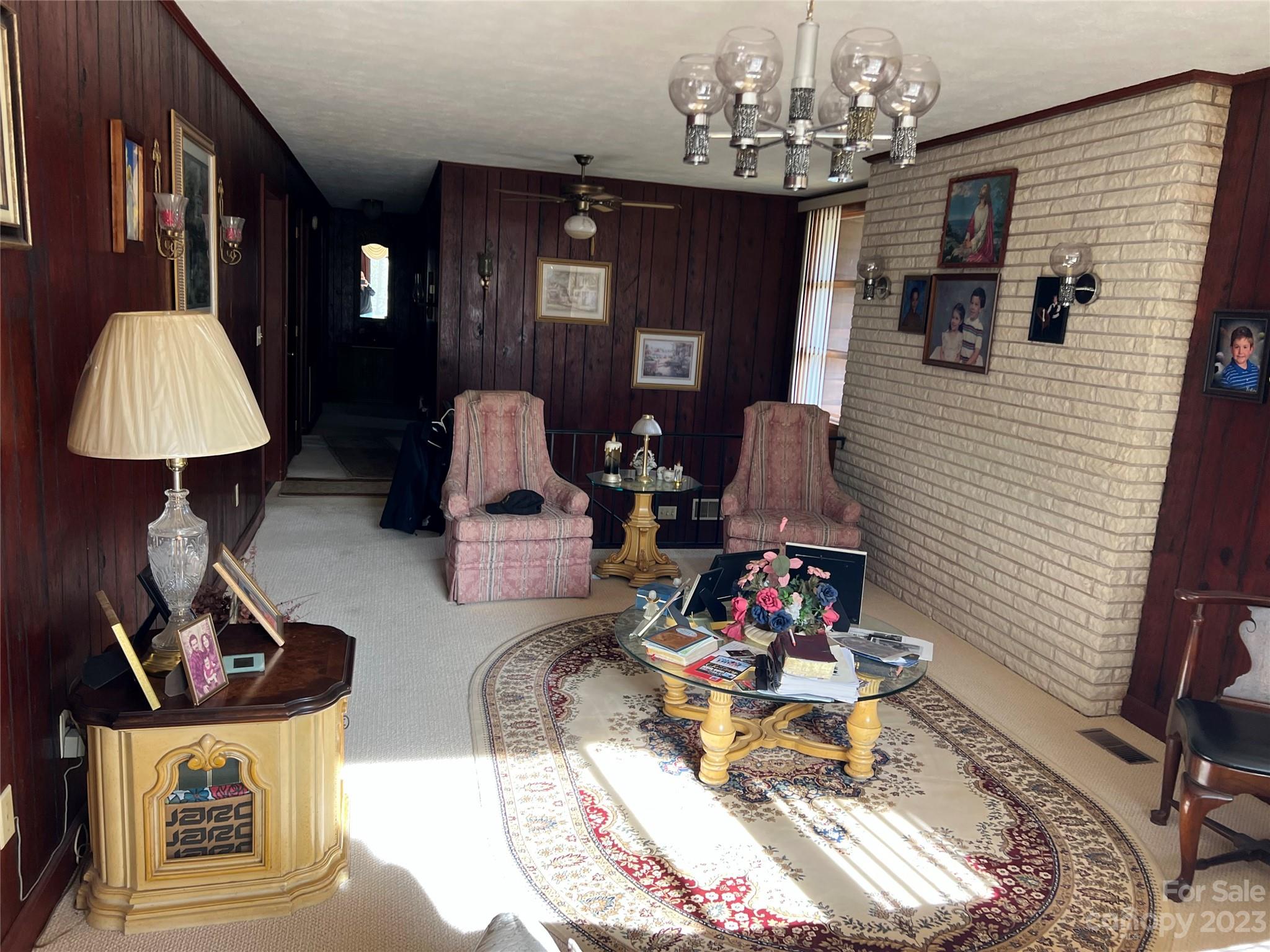 682 Summers Road Valdese, NC 28690 - Photo 18 of 45 a living room with furniture and a chandelier