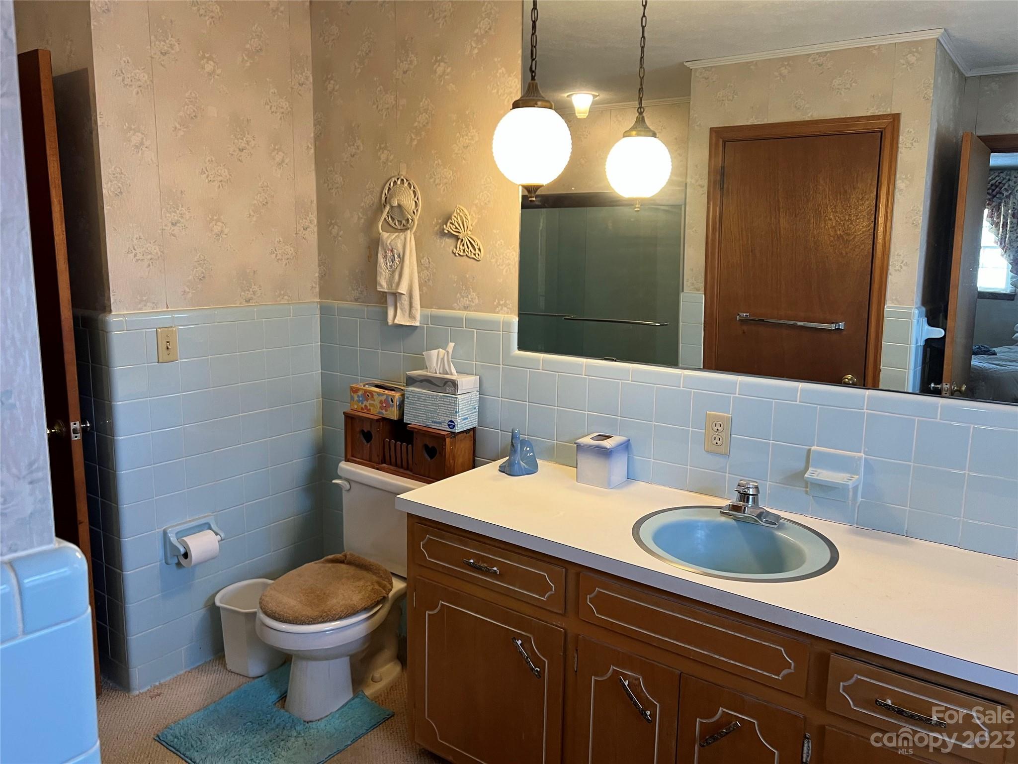 682 Summers Road Valdese, NC 28690 - Photo 23 of 45 a bathroom with a sink a toilet and mirror