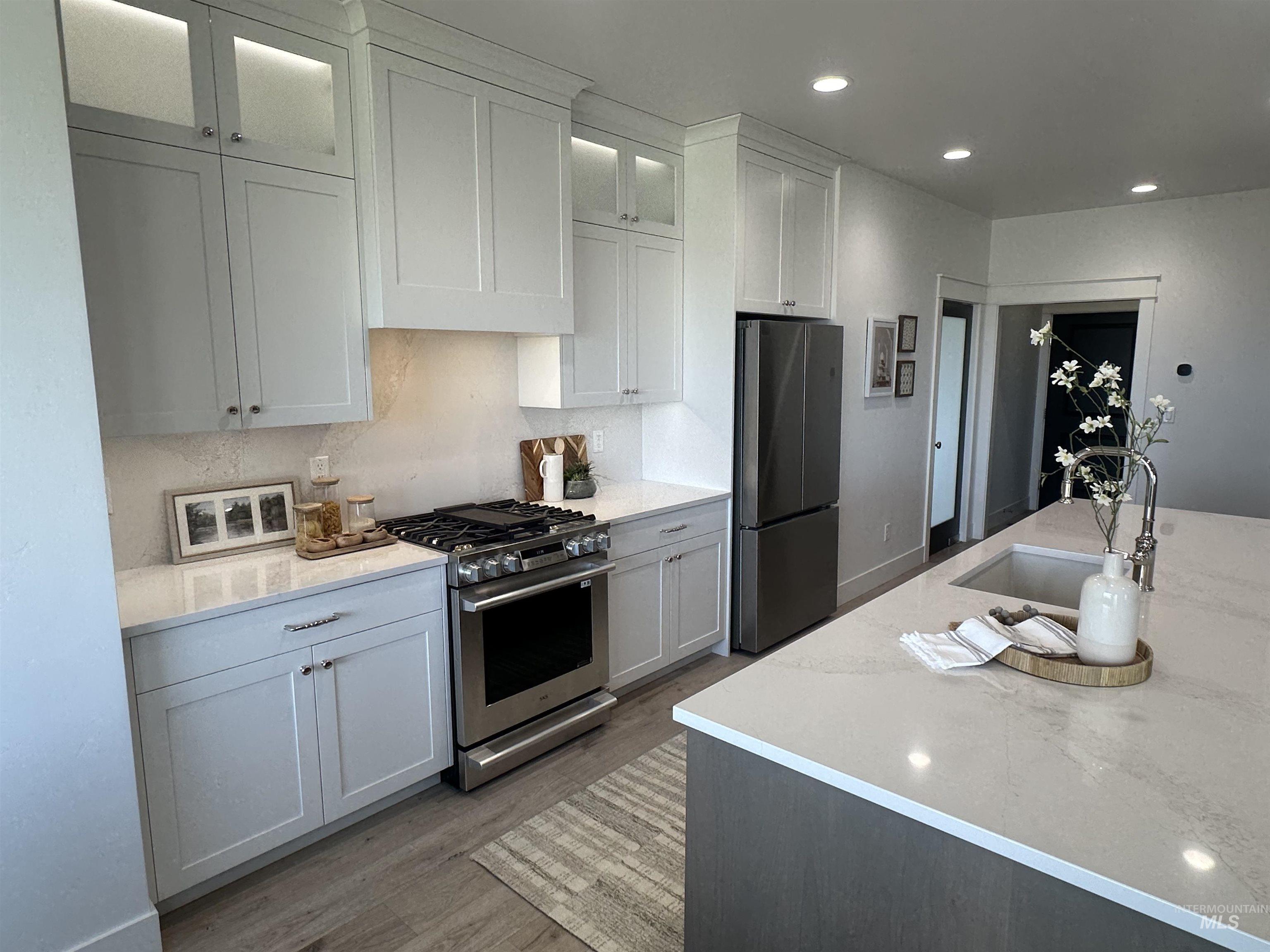 3035 Lake View Twin Falls, ID 83301 - Photo 5 of 41 Modern kitchen featuring white shaker cabinetry, stainless steel appliances, a gas range, and light-toned countertops
