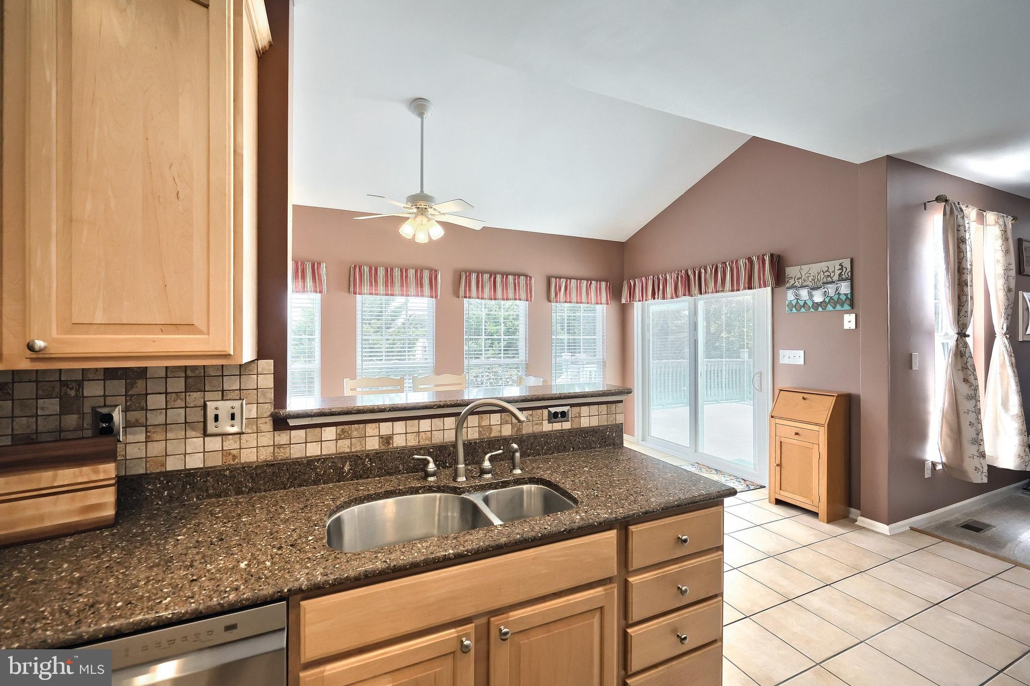 44 Smith Mill Road New Freedom, PA 17349 - Photo 16 of 51 a kitchen with kitchen island granite countertop a sink and a counter top space