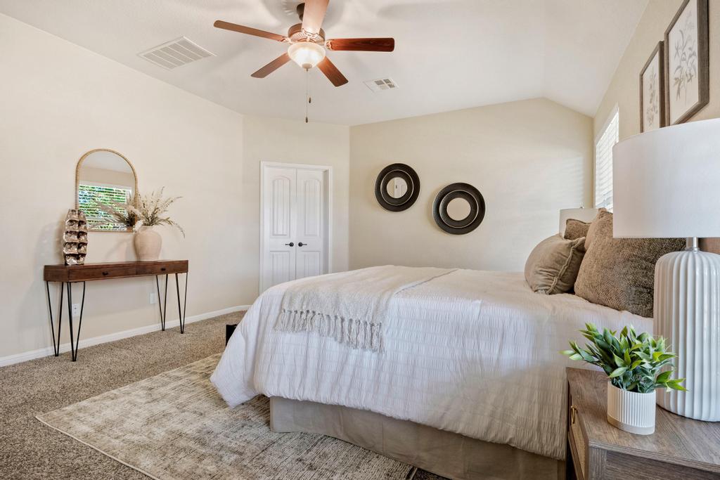 129 Camp Verde Drive Georgetown, TX 78633 - Photo 23 of 39 Main bedroom first floor-Carpeted bedroom featuring lofted ceiling and a ceiling fan