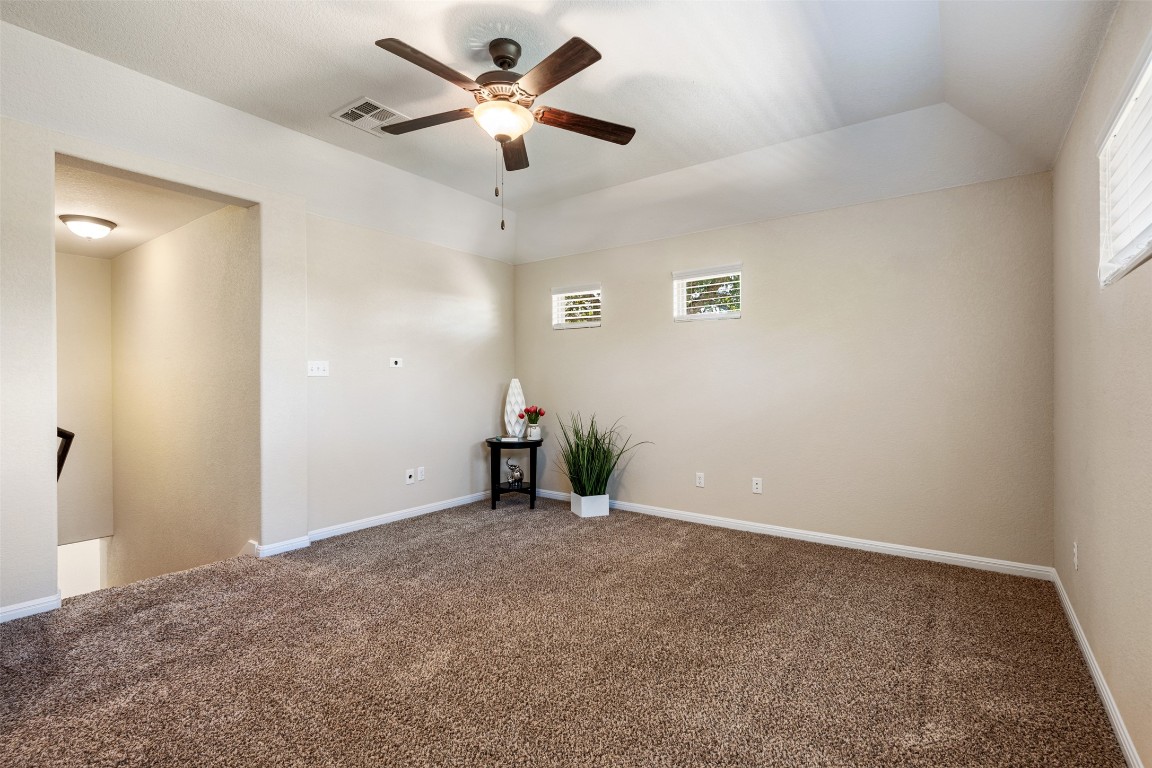 129 Camp Verde Drive Georgetown, TX 78633 - Photo 26 of 39 2nd floor Carpeted living room/game room featuring a ceiling fan and lofted ceiling