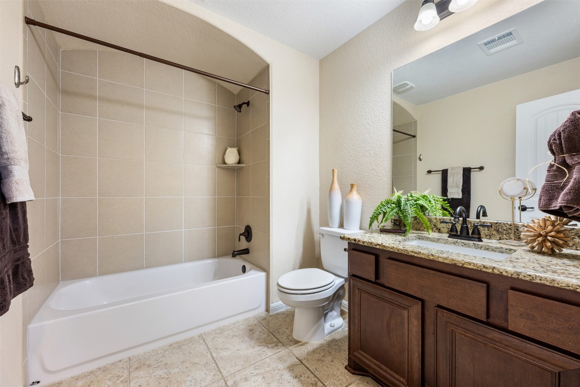 129 Camp Verde Drive Georgetown, TX 78633 - Photo 27 of 39 Full bathroom featuring vanity, tub / shower combination, light tile patterned floors, and a textured wall 2nd floor