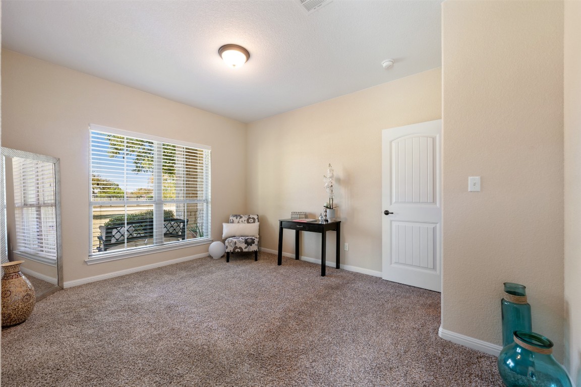 129 Camp Verde Drive Georgetown, TX 78633 - Photo 28 of 39 Bedroom first floor facing front entrance area with carpet floors