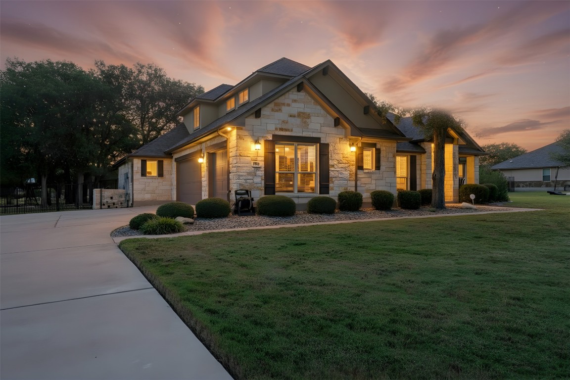 129 Camp Verde Drive Georgetown, TX 78633 - Photo 2 of 39 Craftsman inspired home with stone siding, a lawn, and driveway