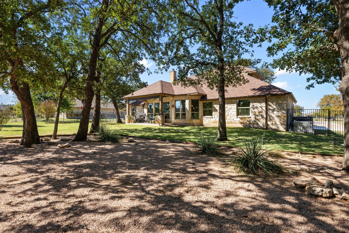 129 Camp Verde Drive Georgetown, TX 78633 - Photo 31 of 39 Back of house featuring a patio area, a chimney, and a shingled roof