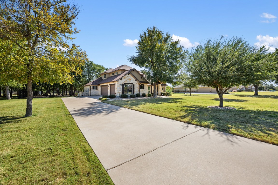 129 Camp Verde Drive Georgetown, TX 78633 - Photo 3 of 39 Craftsman-style home with stone siding, concrete driveway, a front yard, and a garage