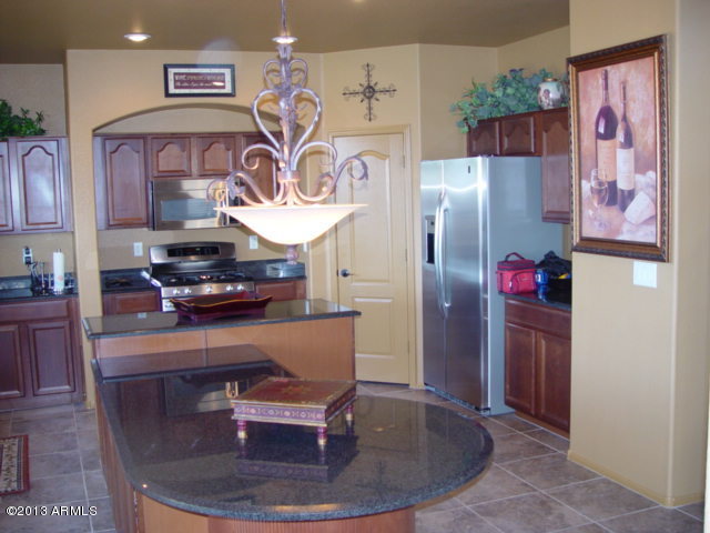 42828 West Venture Road Maricopa, AZ 85138 - Photo 1 of 6 a view of a kitchen with refrigerator and cabinets