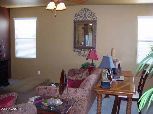 42828 West Venture Road Maricopa, AZ 85138 - Photo 3 of 6 a living room with furniture and a chandelier